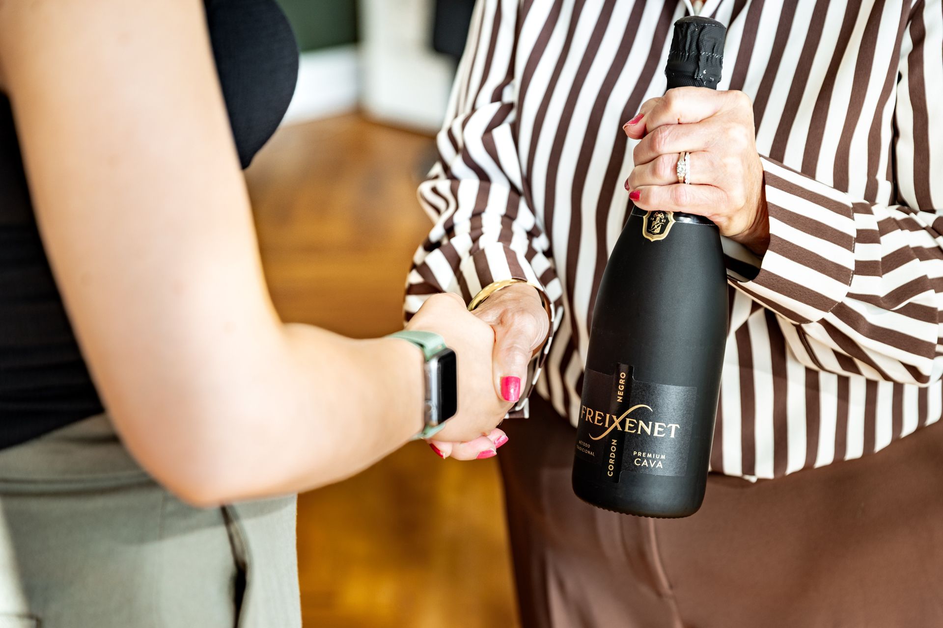 Champagne handed over to celebrate a completed sale