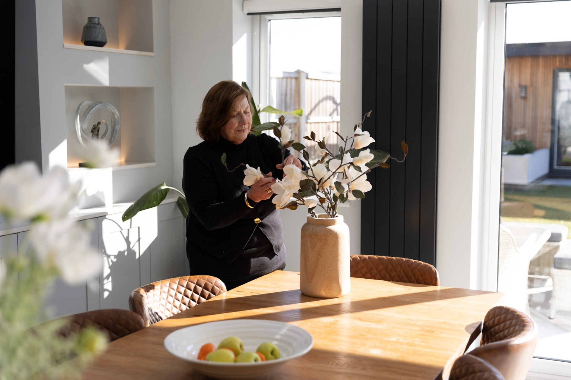 Our home stylist arranging florals in a beautifully styled interior